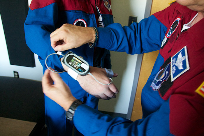 Citizen-astronaut candidates prepare medical sensors for centrifuge run at NASTAR Center